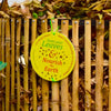 Daily Dump Bamboo leaf composter 32 inches diameter in use in community garden for composting dried leaves with 2 housekeeping staff pressing down to compress pile