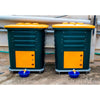 pair of Daily Dump Gaia OWC bulk composters outside apartment building for composting kitchen waste