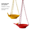 Yellow Bird feeder hanging 3 D against corrugated background