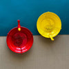 Yellow Bird feeder hanging 3 D against corrugated background
