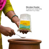 Bamboo Sieve, Microbes Powder, Neem Powder and gloves on corrugated background