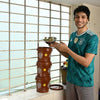 Young man putting bowl of kitchen waste in Daily Dump Gobble solo home composter by indoor window sill and saving 25kg from landfill every year