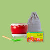 Yellow pot with plate trowel Beej Ball and Compost pack on corrugated background