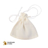 small plain muslin pouch closed with drawstring with loose soapnuts in basket and on ground