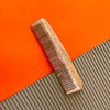 Neem Comb flat on a corrugated and orange background