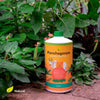 Daily Dump Panchagavya 1 litre bottle with background of tomato plants with healthy red tomatoes