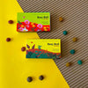 Daily Dump Beej Ball seedballs greens seedmix in box with background of lush greens growing
